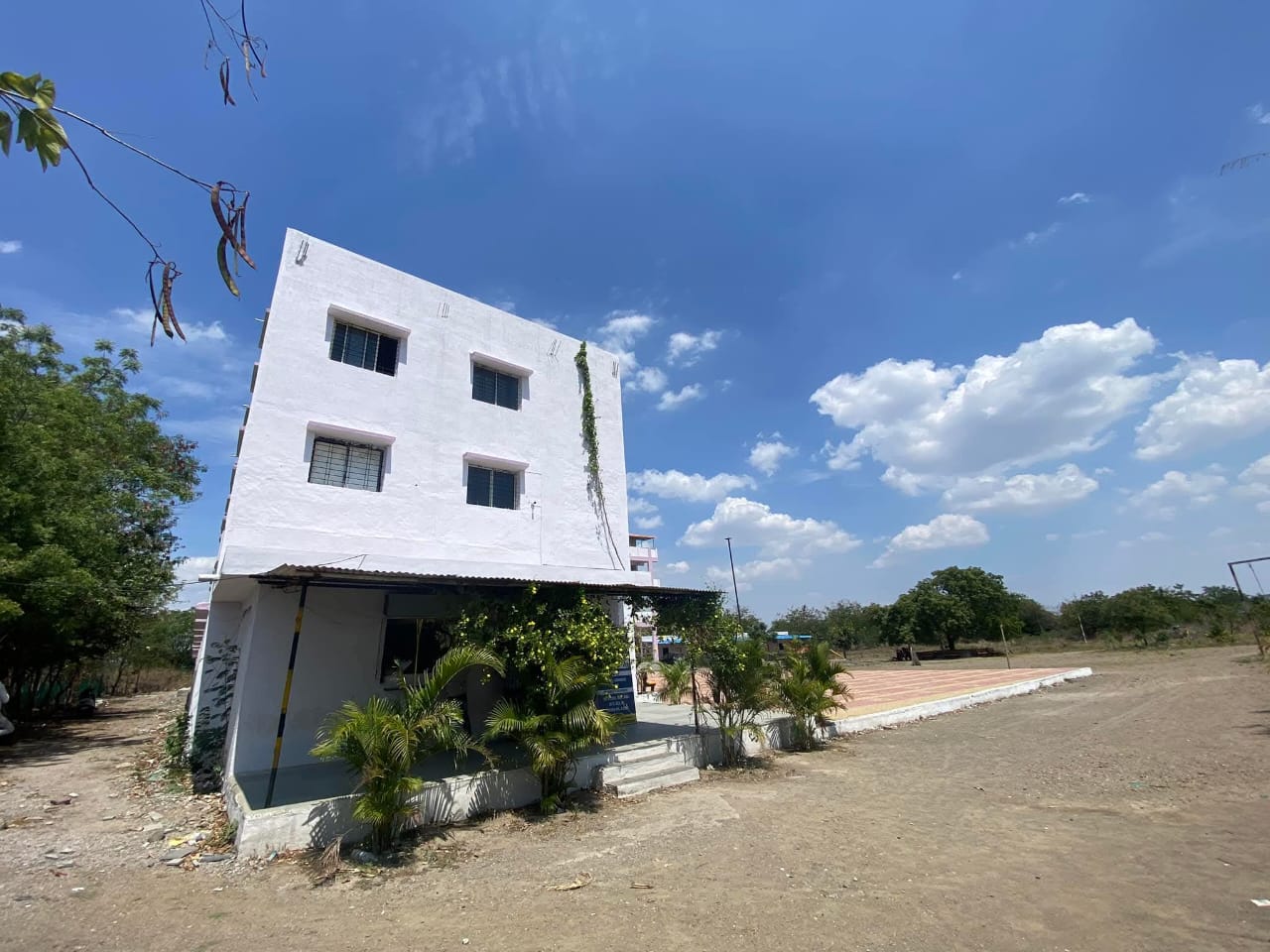 A campus building with gardens in front